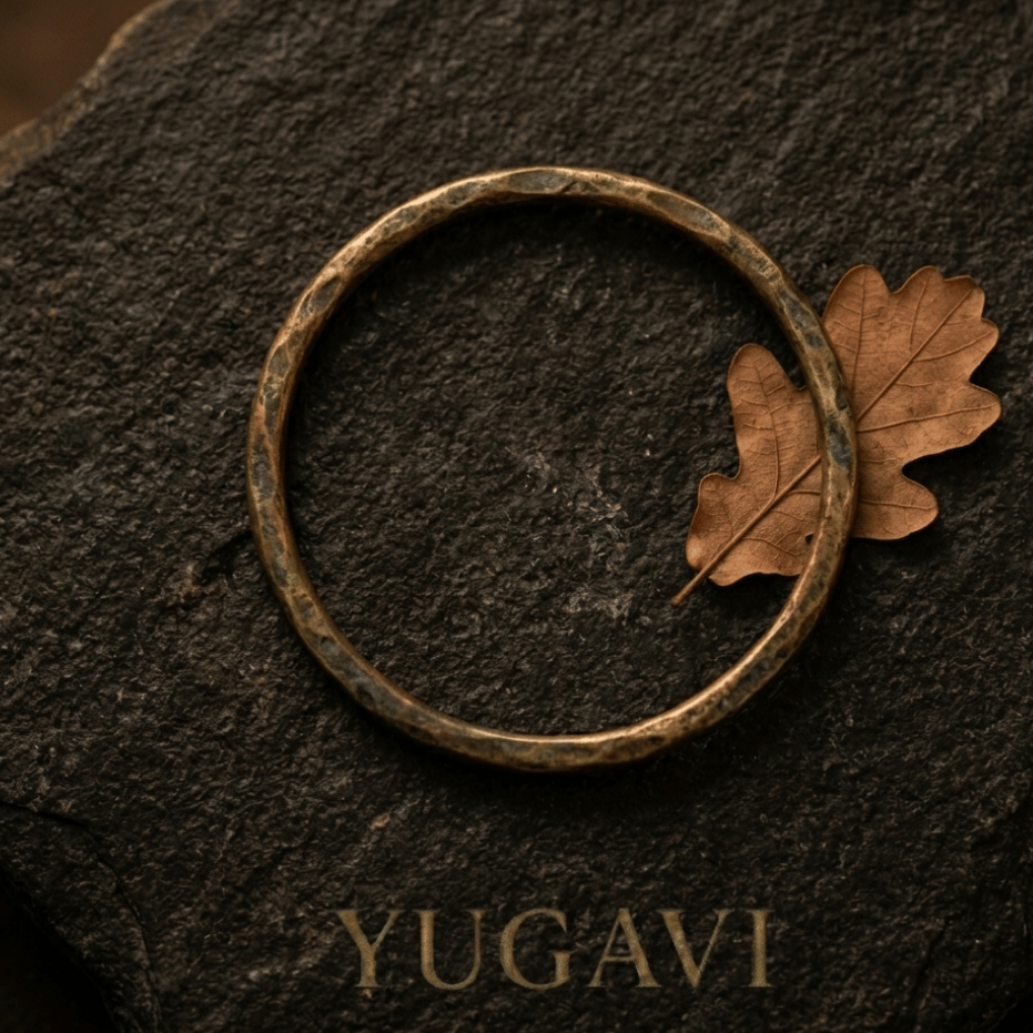 Antique brass bangle on dark stone — Yugavi Kansyam Brass Legacy collection