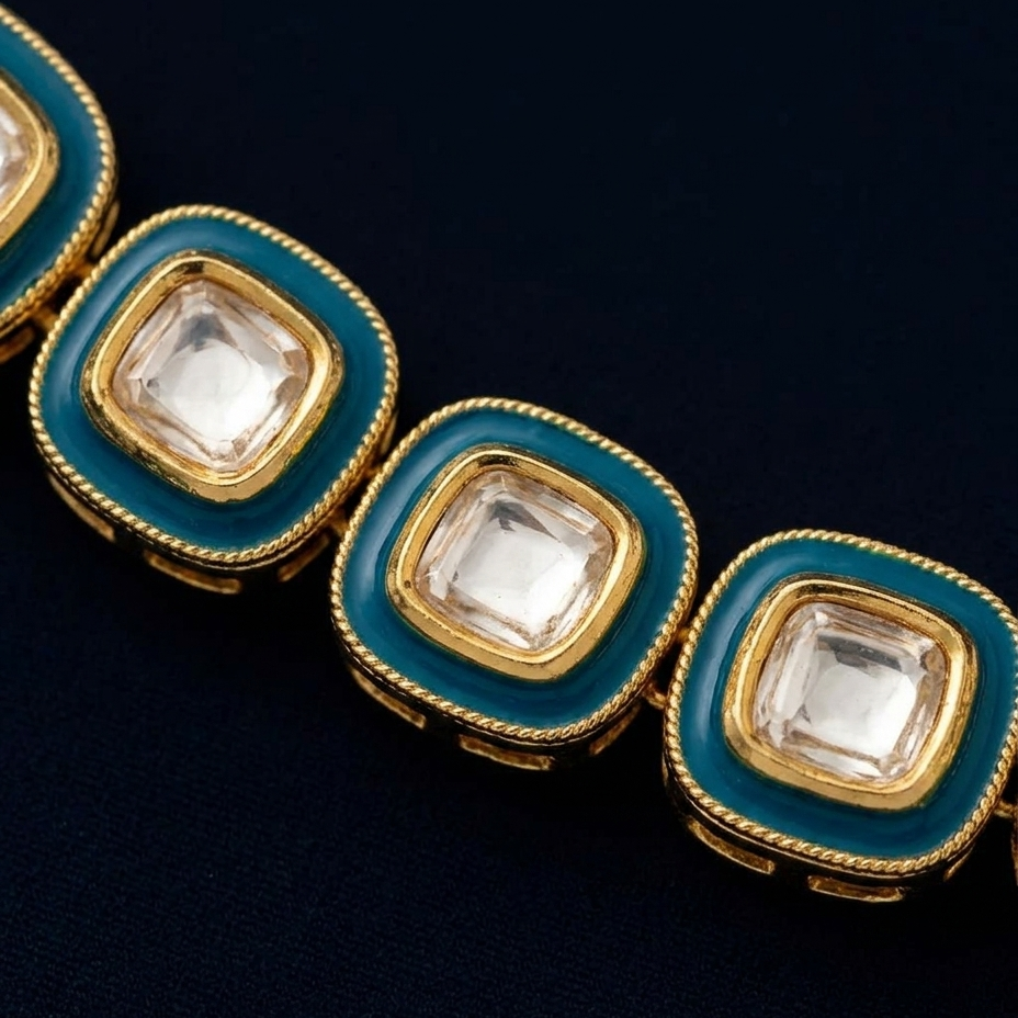 A close-up of a gold-toned bracelet featuring square-shaped clear stones surrounded by a vibrant teal enamel border and a gold rope detail.