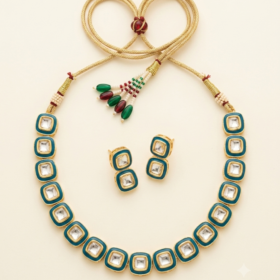 A gold-plated jewelry set featuring a necklace and matching earrings with square-cut clear stones bordered by teal green enamel and gold frames, arranged on a light cream background.