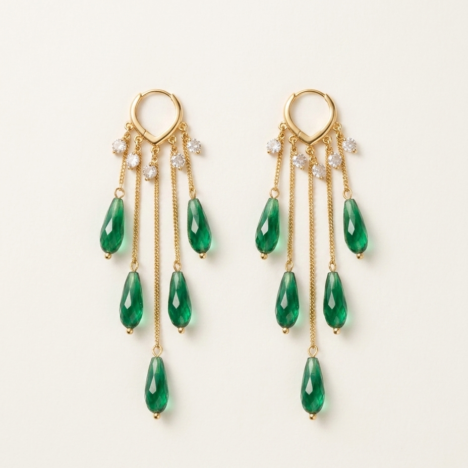 A pair of gold dangle earrings with five green teardrop gemstones and small clear crystal accents, displayed on a clean off-white background.