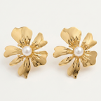 A pair of gold flower-shaped stud earrings with a central white pearl, displayed on a clean off-white background.