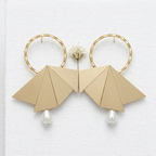 A pair of gold hoop earrings with geometric fan-shaped drop elements and small pearl drops, displayed on a white textured card.