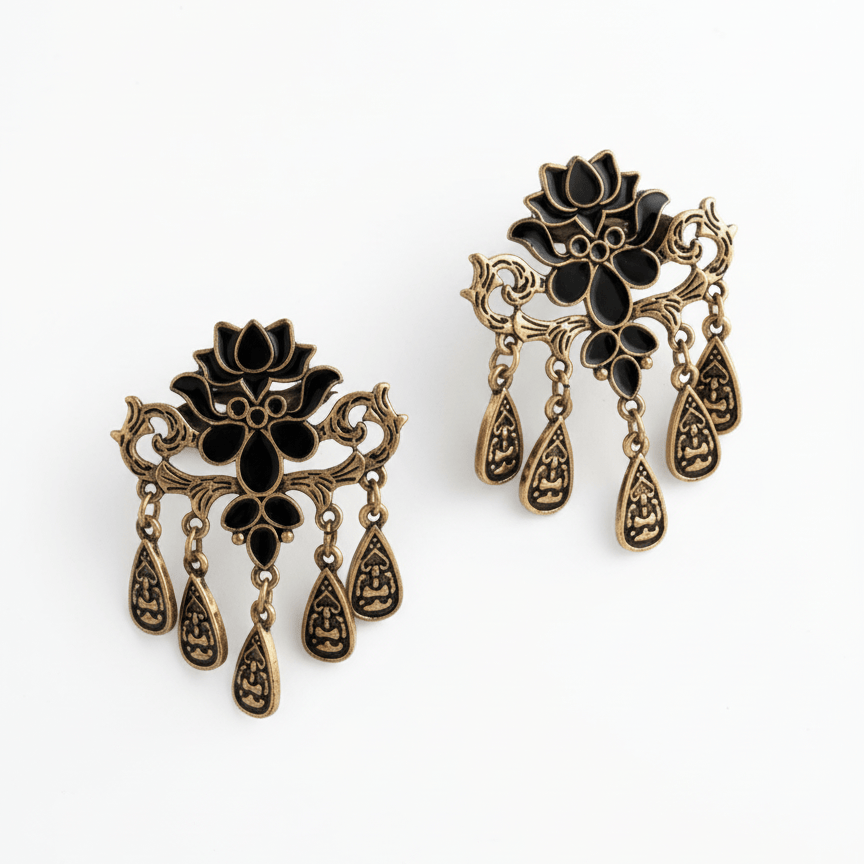 Black and antique gold lotus drop earrings with dangling design by Yugavi on clean background
