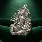 Silver decorative figure on a green textured background