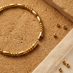 Close-up of Yugavi Granthi Bracelet — elongated barrel beads alternating with round disc bead clusters in warm 22K gold — Yugavi Jewels