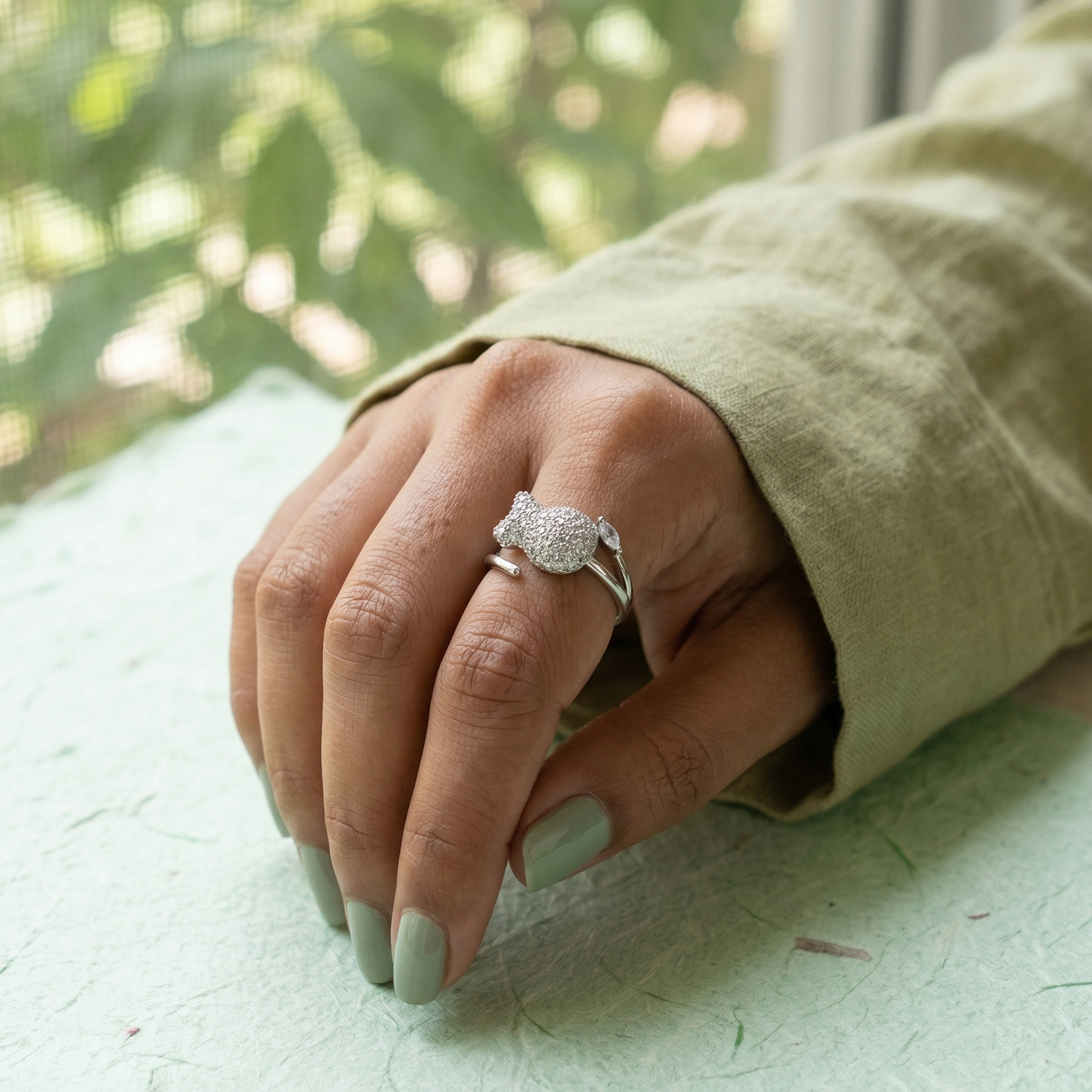 Close-up of Yugavi Mishti Ring — densely set round pavé cubic zirconia bow cat face with marquise CZ shank accent on silver bypass band