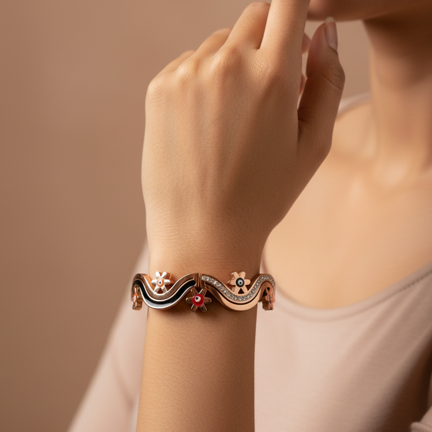 Close-up of a hand wearing an ornate bracelet on a beige background