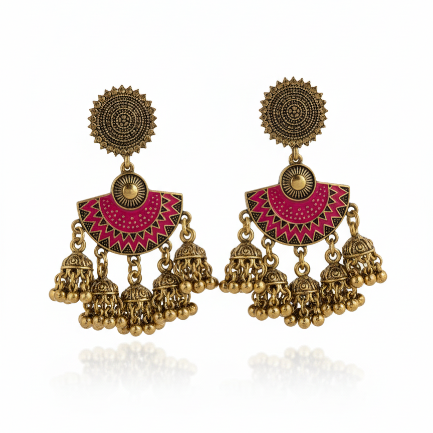 Detail of Yugavi Devanshi triple jhumka cascade — three antique gold engraved dome jhumka bells with bead drops hanging at graduated heights from the magenta enamel arch base, showing the cascading bell arrangement