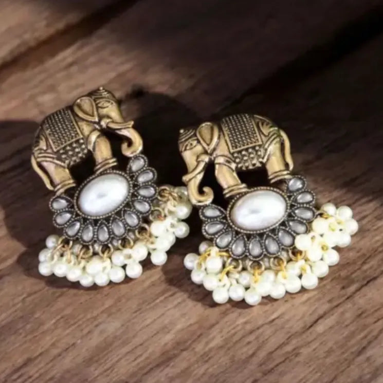 Detail of Yugavi Keshvi pearl fringe — three dense rows of white seed pearls on individual gold links cascading from the base of the moonstone lotus, the fullest pearl fringe in the Kansyam Collection, ivory and antique gold