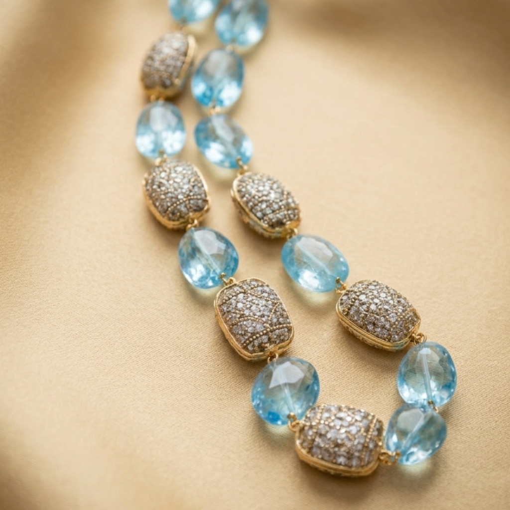 Necklace with blue beads and gold accents on a beige background