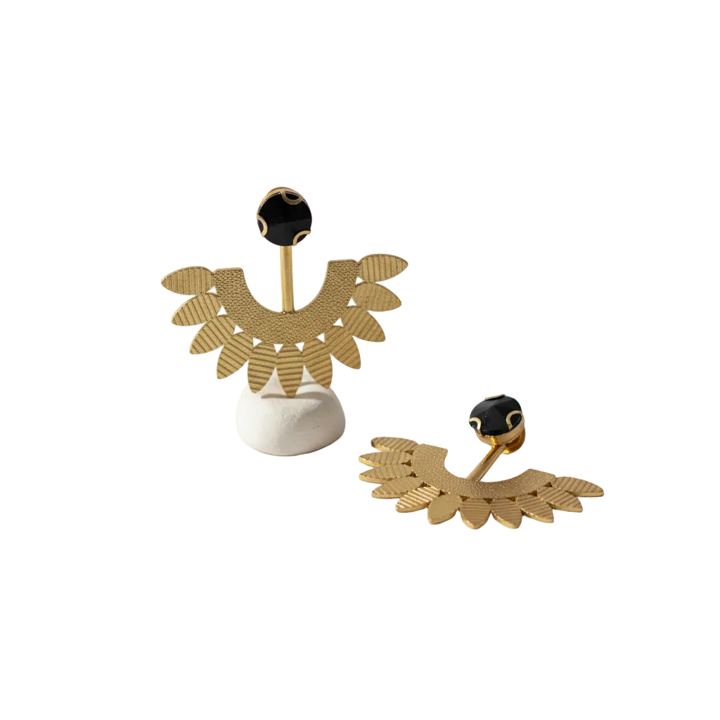 Gold earrings with black stones on a white stand, branded 'Yugavi'.