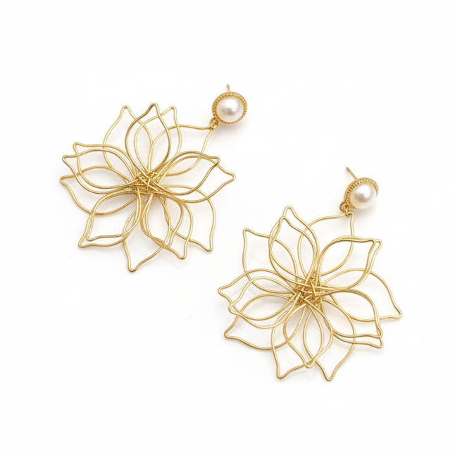 Gold floral earrings on a white background