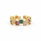 Gold hoop earrings with multicolored gemstones on a white background