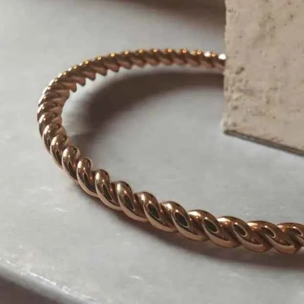 Rose gold bracelet on a light surface