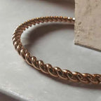 Rose gold bracelet on a light surface