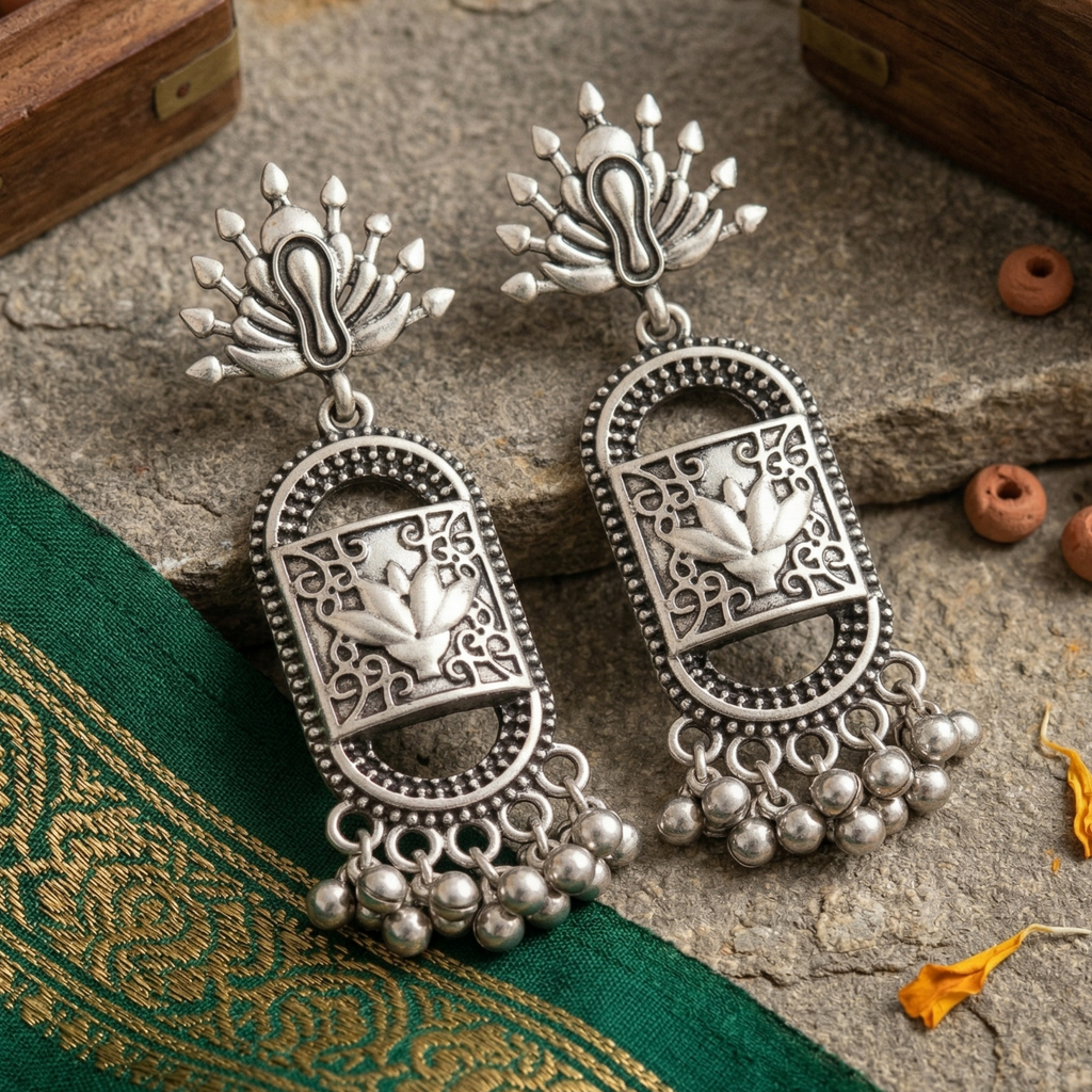 Silver lotus motif earrings with intricate traditional detailing