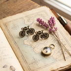 Yugavi Kashana antique brass vintage bicycle stud earrings displayed as a pair on white background — fully detailed miniature road bicycle with individually rendered spokes, curved handlebars, seat, frame and pedal crank, warm antique oxidised brass finish, House of Yugavi Kavya Collection