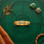 Yugavi Mangal Bracelet flat lay — gold slim sacred symbol bangle — Yugavi Sacred Circle Collection — stacked with Yugavi Dev — houseofyugavi.com