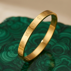 Yugavi Mangal Bracelet — slim 22K gold flat bangle with Om Swastik Shankha Chakra Lotus sacred symbol engravings — houseofyugavi.com
