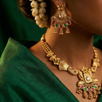 Yugavi Mayuri antique gold peacock earring pair front view — flower stud top with green cabochon, engraved triangular body with white kundan, peacock scroll sides, alternating ruby red and emerald green teardrop stone fringe with ghungroo drops — House of Yugavi