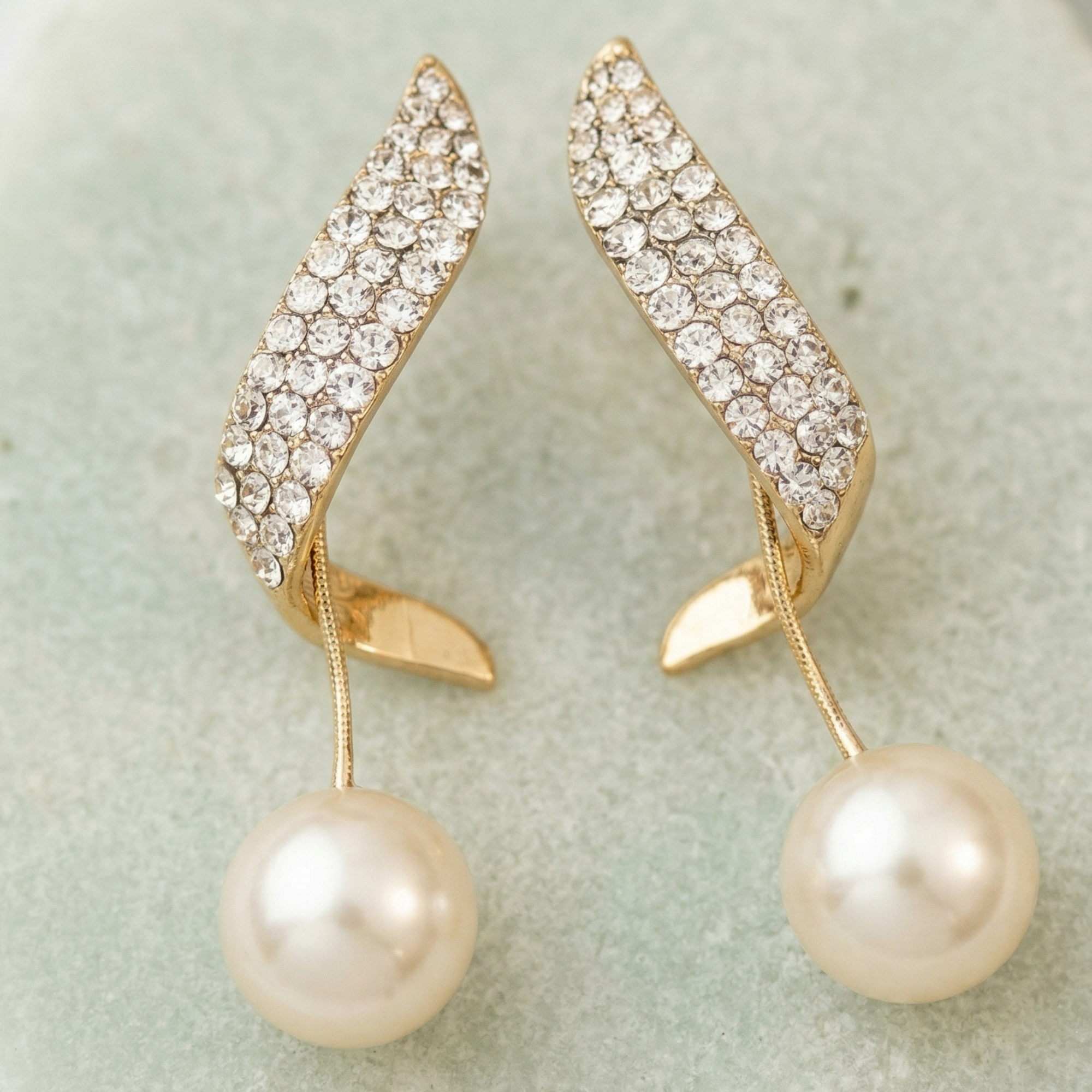 Yugavi Pallavi Earrings — gold curved pavé CZ leaf stud with large pearl drop on fine gold stem — houseofyugavi.com