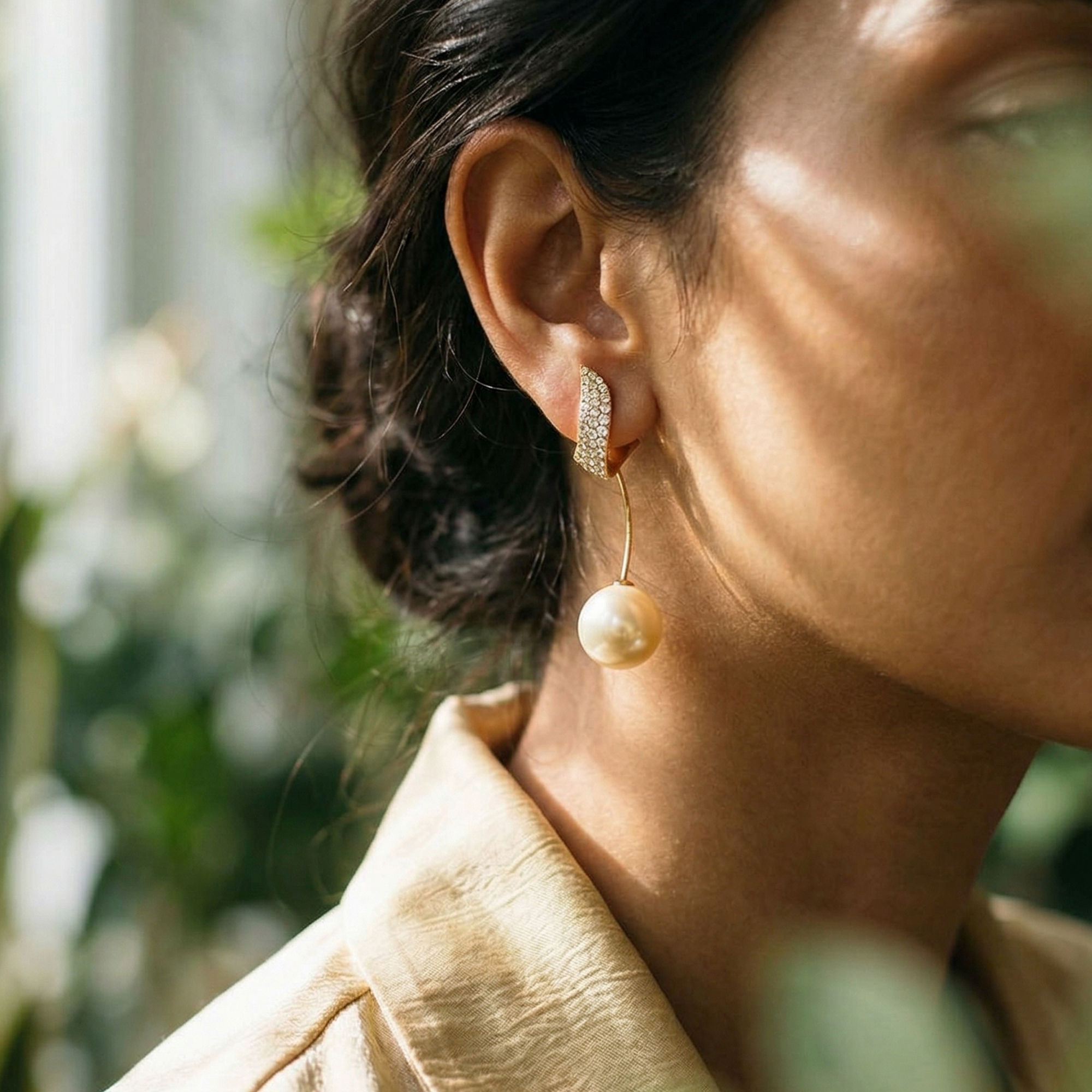 Yugavi Pallavi gold pavé leaf earrings with pearl drop worn on ear — bridal festive earrings — Yugavi Bloom Collection — Yugavi Jewels