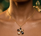 Yugavi Pushpa gold flower pendant necklace with alternating black enamel and champagne crystal petals and single white CZ centre stone on delicate gold cable chain, front view — House of Yugavi