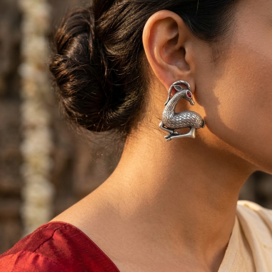 Woman wearing a silver earring with a blurred background