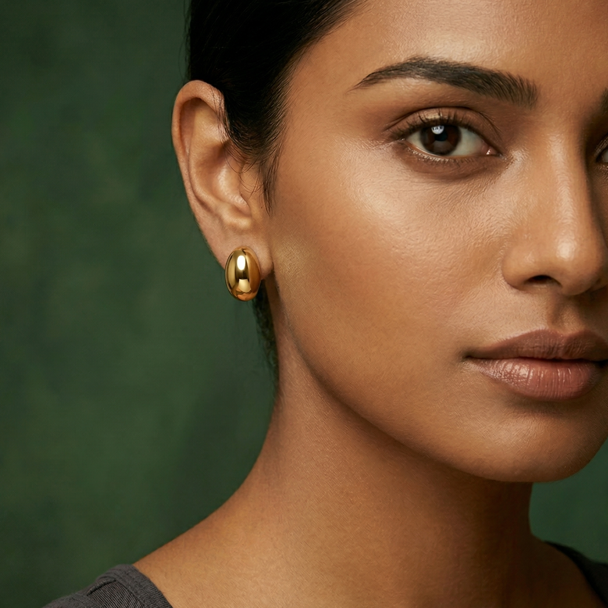 Yugavi Samika chunky oversized gold dome stud earrings in high mirror polish 18K gold, smooth hollow sculptural dome silhouette, top angle view pair