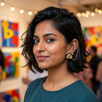 Woman wearing a teal shirt with colorful abstract art in the background