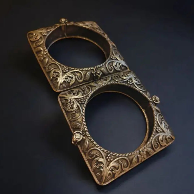 Decorative brass bottle opener on a dark background
