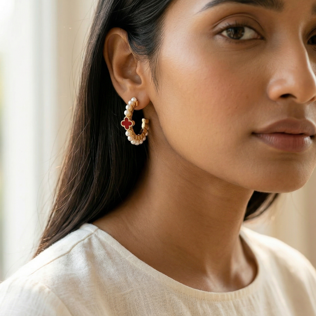 Woman wearing a pair of earrings with a neutral background