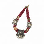 Decorative necklace with braided design and ornate metal elements on a white background