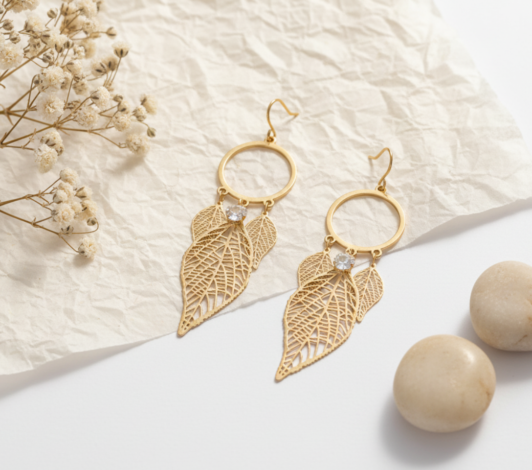 Yugavi Palasha gold filigree leaf drop earrings with open circle hoop top and triple cascading leaf charms with single white CZ stone, matte gold finish, front view on white background — House of Yugavi