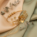 Yugavi Vana gold floral filigree open cuff bangle with scrolling vine openwork, small flower cutouts, gold bead accents and raised 3D dimensional centre flower bloom with oxidised dark petals, front view