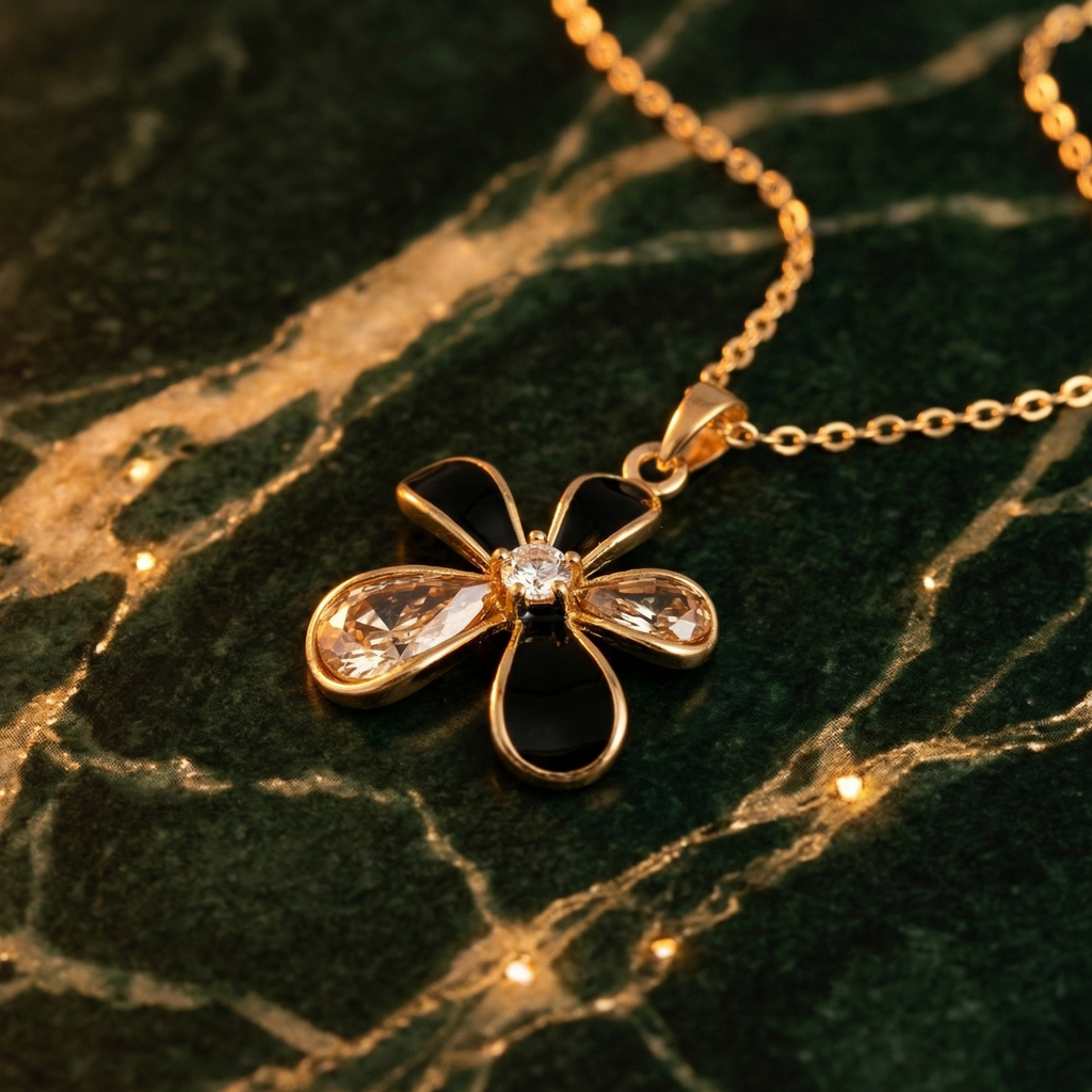 Gold necklace with a butterfly-shaped pendant on a marble surface