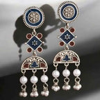 Detail of Yugavi Nilambari diamond connector — square form rotated 45 degrees in navy blue enamel with engraved flower centre and four rust terracotta round enamel dots at cardinal points, oxidised silver setting, meenakari enamel work