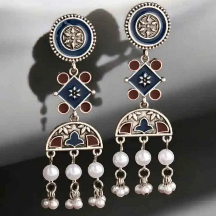 Detail of Yugavi Nilambari diamond connector — square form rotated 45 degrees in navy blue enamel with engraved flower centre and four rust terracotta round enamel dots at cardinal points, oxidised silver setting, meenakari enamel work